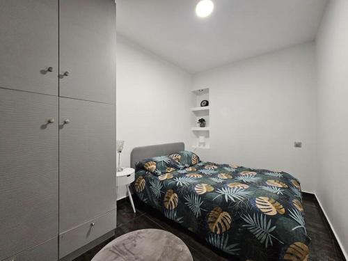 a bedroom with a bed and a cabinet and a sink at Appartement Proche Metro Paris in Pantin