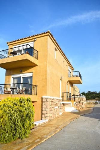 a building with balconies on the side of it at Elafonisos Mare in Elafonisos