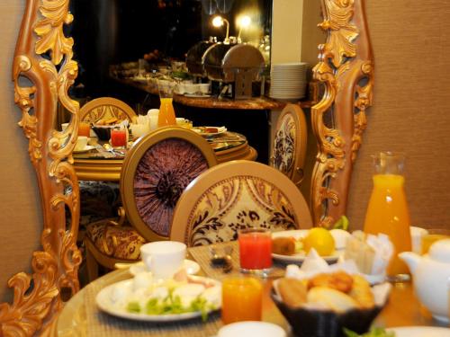 a table with plates of food in front of a mirror at Q Hotel in Beirut