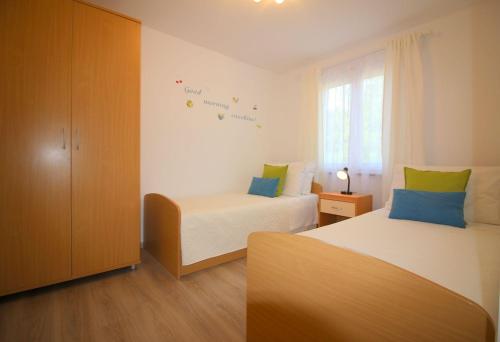 ein kleines Schlafzimmer mit 2 Betten und einem Fenster in der Unterkunft Ferienhaus  Lavanda 2 in Poreč