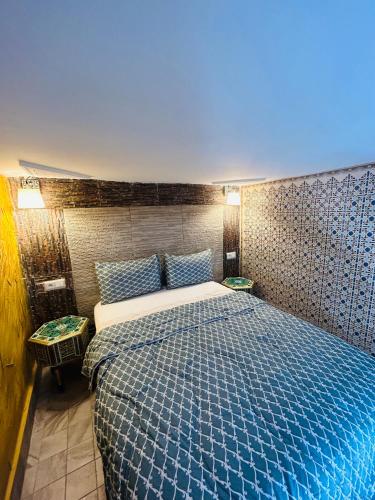 a bedroom with a blue bed in a room at RIAD ESMERALDA By Dar Ouezzani in Rabat