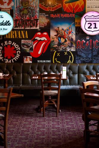 a restaurant with a bunch of posters on the wall at The Saddle Inn in Chester