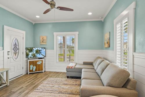 a living room with a couch and a tv at Alister House in Port Aransas