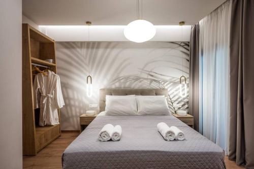 a bedroom with a bed with two towels on it at Amalia's Luxury Apartment 2 in Heraklio Town