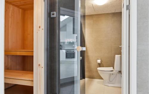 a bathroom with a toilet and a glass door at Aqua 221 in Charlottenthal