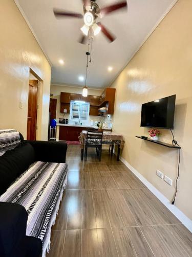 a living room with a couch and a flat screen tv at Patterville Transient House in Iba