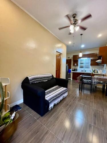a living room with a couch and a kitchen at Patterville Transient House in Iba