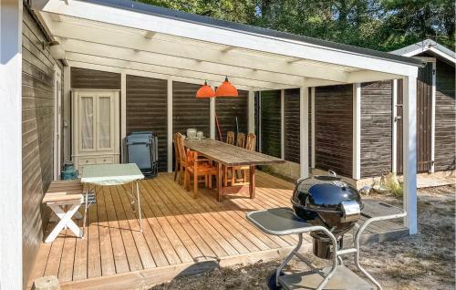 a wooden deck with a table and chairs on it at 2 Bedroom Beautiful Home In Löderup in Löderup