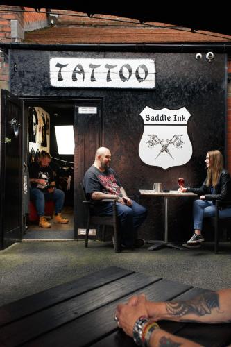a group of people sitting outside of a sa cafe at The Saddle Inn in Chester