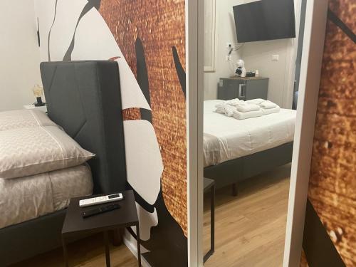 two pictures of a bedroom with a bed and a mirror at Cucchiari Suite 8A in Modena