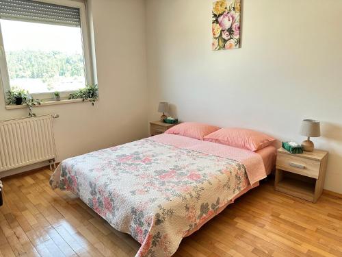 a bedroom with a bed and a window at Titanik Tuzla in Tuzla