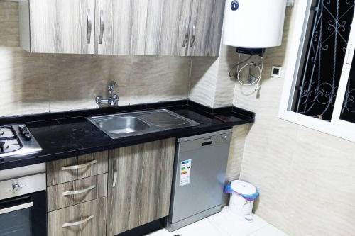 a small kitchen with a sink and a stove at Appart prestigieux+T bien équipé in Fès