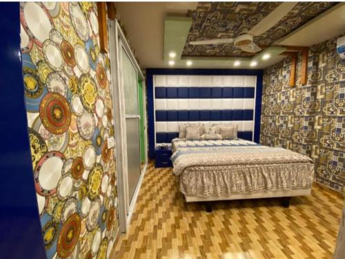 um quarto com uma cama e uma parede com um mural em Muhammad homes&land em Islamabad