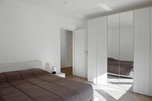a bedroom with a large bed and a glass wall at Chalet Francesca in Pieve di Cadore