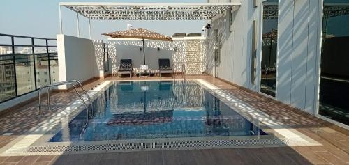 a swimming pool on top of a building at AKASIYA HOTEL in Doha