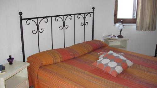 a bedroom with a large bed with pillows on it at B&B Supramonte in Orgosolo