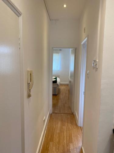 a hallway with a door leading to a bedroom at The London apartment in London