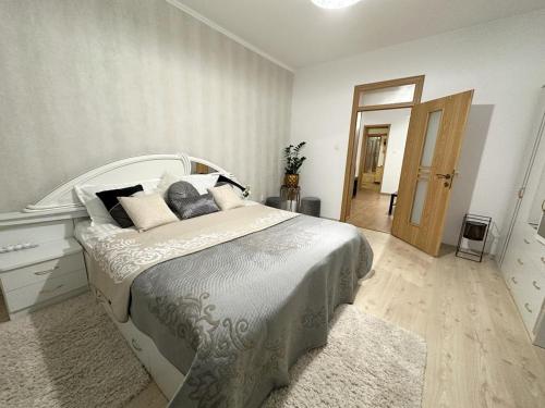 a bedroom with a large bed and a hallway at Flamingo House in Reghin