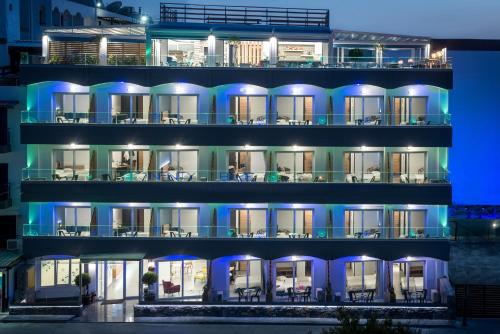 an apartment building at night with blue lights at Infinity Blue Boutique Hotel & Spa - Adults Only in Hersonissos
