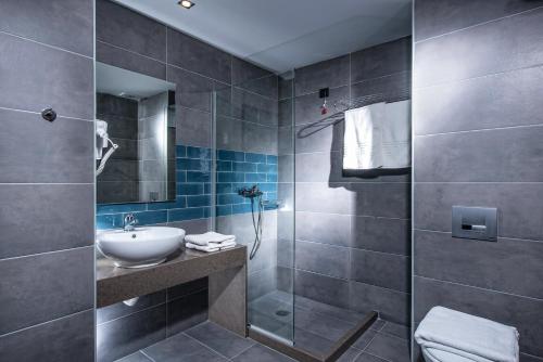 a bathroom with a sink and a shower at Infinity Blue Boutique Hotel & Spa - Adults Only in Hersonissos