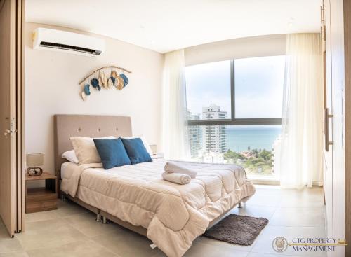 Кровать или кровати в номере Salguero Suites, Playa Salguero Santa Marta