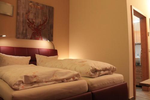 a bed with two pillows on it in a room at Winklmoos Sonnenalm in Reit im Winkl
