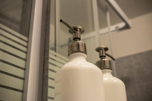 a close up of a bottle on a bathroom sink at Apartman "A" in Szeged