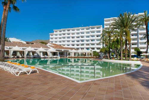a swimming pool in front of a hotel at Iberostar Ciudad Blanca in Port d'Alcudia