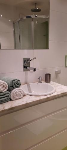 a bathroom counter with a sink and a mirror at Apartament Centrum przy Parku Zdrojowym in Nałęczów