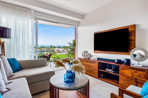 a living room with a couch and a tv at D'Toscana Residencial # 305 in Nuevo Vallarta 