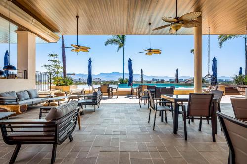 a patio with tables and chairs and a pool at D'Toscana Residencial # 305 in Nuevo Vallarta 