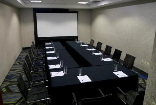 a conference room with a long table and chairs at Holiday Inn Express Brampton by IHG in Brampton