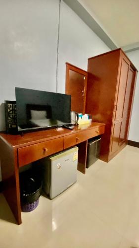 a kitchen with a wooden desk with a microwave at ริเวอร์ไซด์ อพาทเมนต์ in Udon Thani