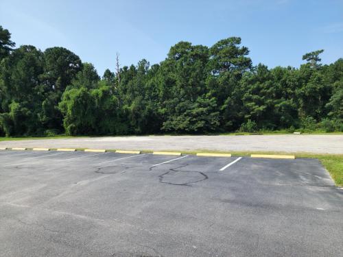 an empty parking lot with a yellow line in it at Days Inn by Wyndham Hardeeville Near Hilton Head in Hardeeville