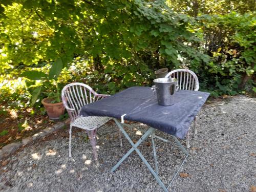 a blue table with two chairs and a bucket on it at viarhona in Montélimar