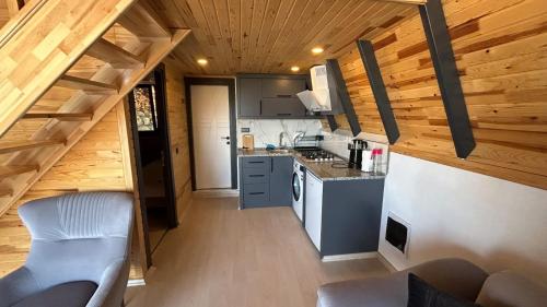 a kitchen in a tiny house with wooden ceilings at Ay-Ra Bungalow Suite in Kas
