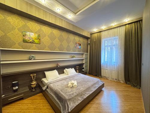 a bedroom with a bed and a large window at Sahil Lux in Baku