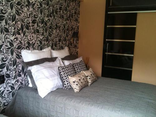a bed with pillows on it in a bedroom at Flat no Hotel Cavalinho Branco in Águas de Lindóia
