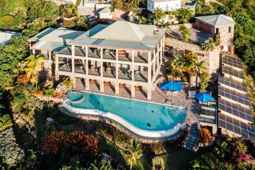 an aerial view of a resort with a swimming pool at Beautiful 3 story 8,000 sq ft Oceanside Mansion in Nevis
