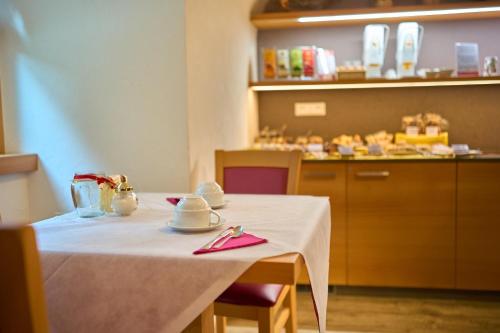 a table with a white table cloth on it at DolceVita Ambiez B&B in San Lorenzo in Banale