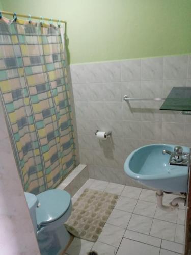 a bathroom with a toilet and a sink and a shower at Zumag Sisa in Tena
