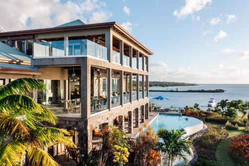 an image of a house with a swimming pool and the ocean at Beautiful 3 story 8,000 sq ft Oceanside Mansion in Nevis