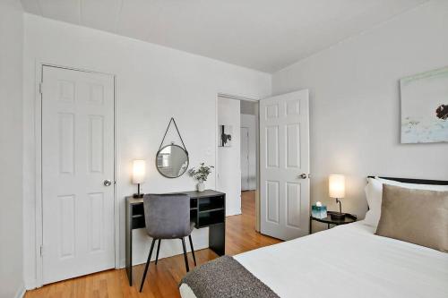 1 dormitorio con cama y escritorio con espejo en Chic and Furnished 1BR Apartment - Harlem B14, en Chicago