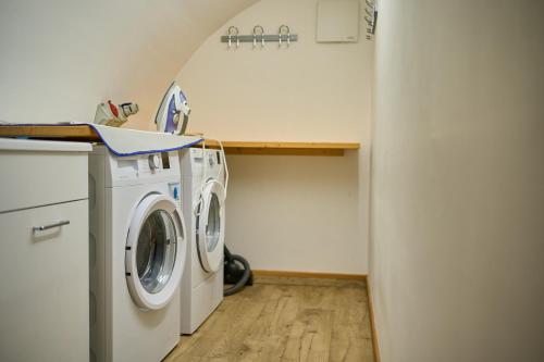 a laundry room with a washer and dryer at DolceVita Ambiez B&B in San Lorenzo in Banale