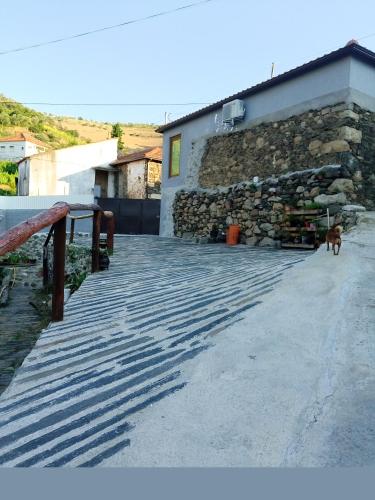 a dog standing on a ramp next to a building at O cantinho da Laura in Lamego