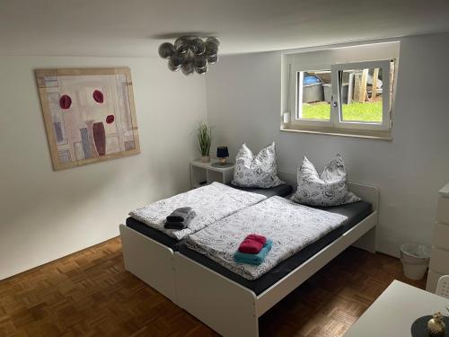 1 dormitorio con cama con almohadas y ventana en Cal-ifornia Home 2, en Núremberg
