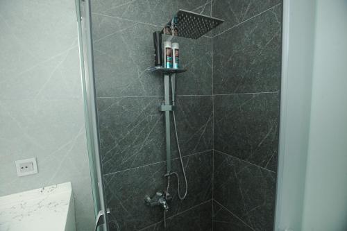 a bathroom with a shower with a glass door at Welcome Inn in Baku