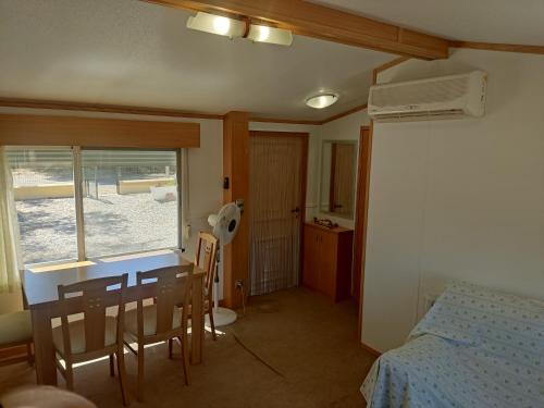 a bedroom with a table and a bed and a table and chairs at Casa rural cerca playa de Villaricos in Las Bombardas