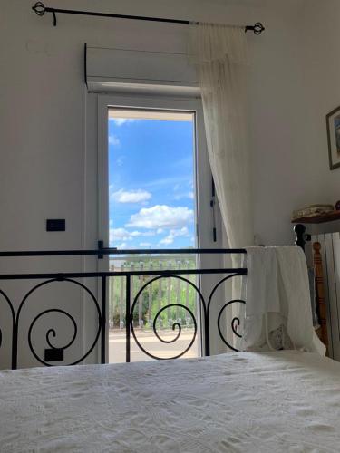Ένα ή περισσότερα κρεβάτια σε δωμάτιο στο Villa Murgese