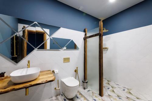 a bathroom with a sink and a toilet at Mtserlebi Resort in K'vishkhet'i